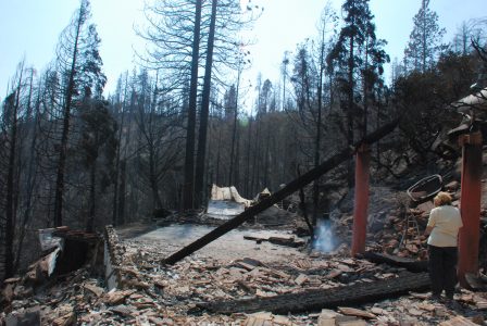 Image of smoke rising from burned debris on the driveway