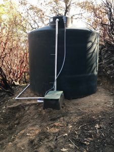 Image of a new 2500 gallon water tank and plumbing