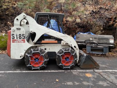 Image of Bobcat with tire chains installed