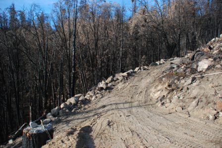 Image of a new dirt road edged with boulders