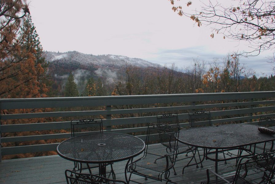 Image of mountains across the valley half-covered with snow