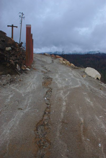 Image of a small erosion channel in the middle of a dirt road