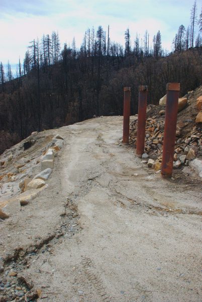 Image of small erosion channels running through the former breezeway of the Logger's Retreat