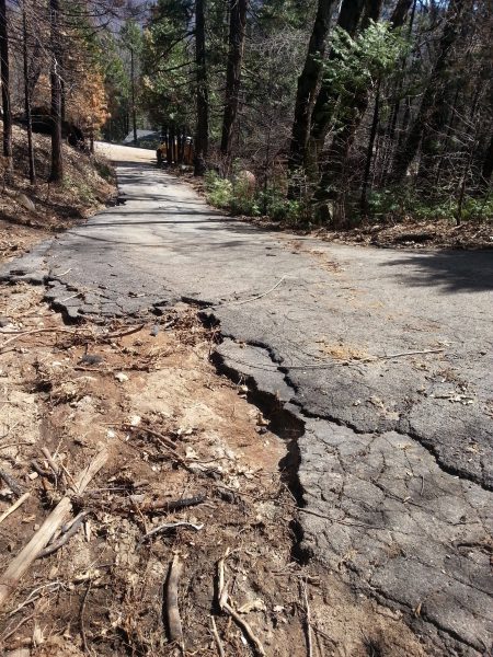 Image of broken asphat at the edge of the driveway